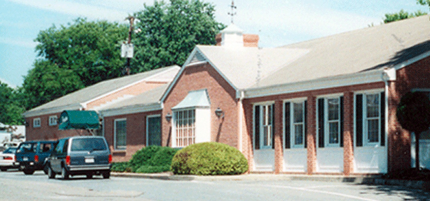 Brick commercial office building with cars parked out front where we installed a central vacuum system