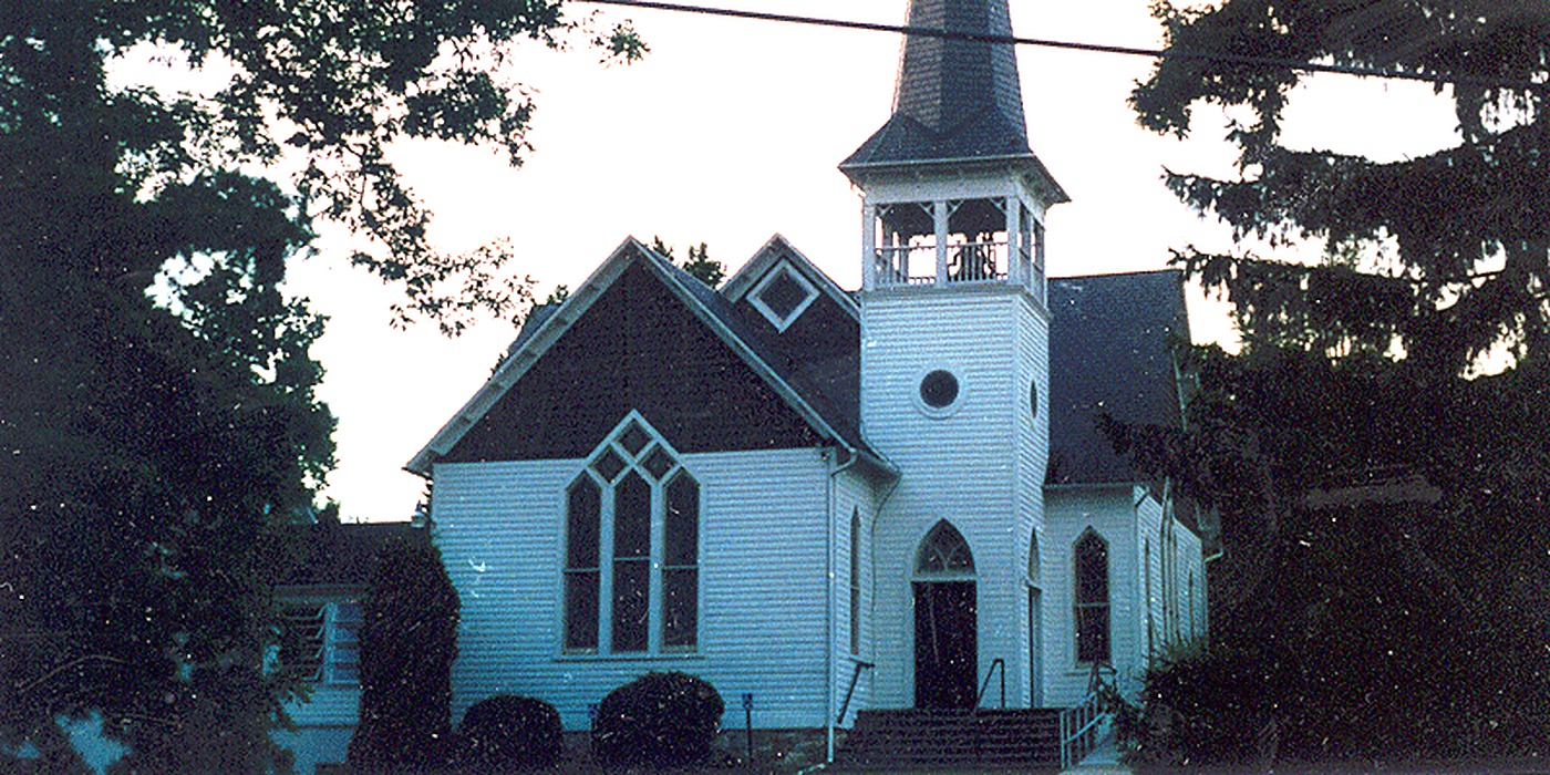 White clapboard country church with a steeple and bell tower where we installed a central vacuum system