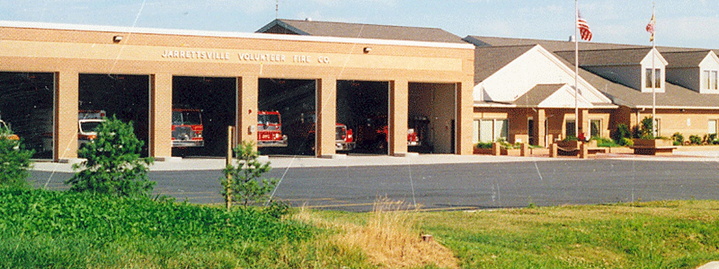 Jarrettsville Volunteer Fire Company fire station with open apparatus bays and fire trucks visible inside, a public building central vacuum install