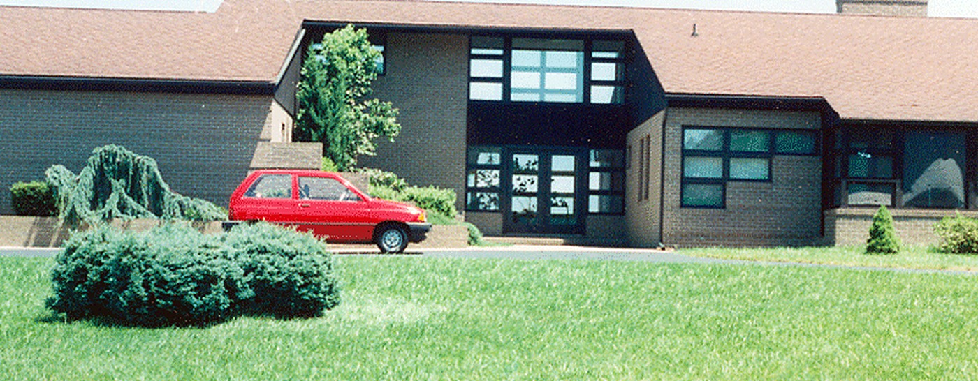 Contemporary style home with a red car in the driveway, a new construction central vacuum installation by A Plus Oaks
