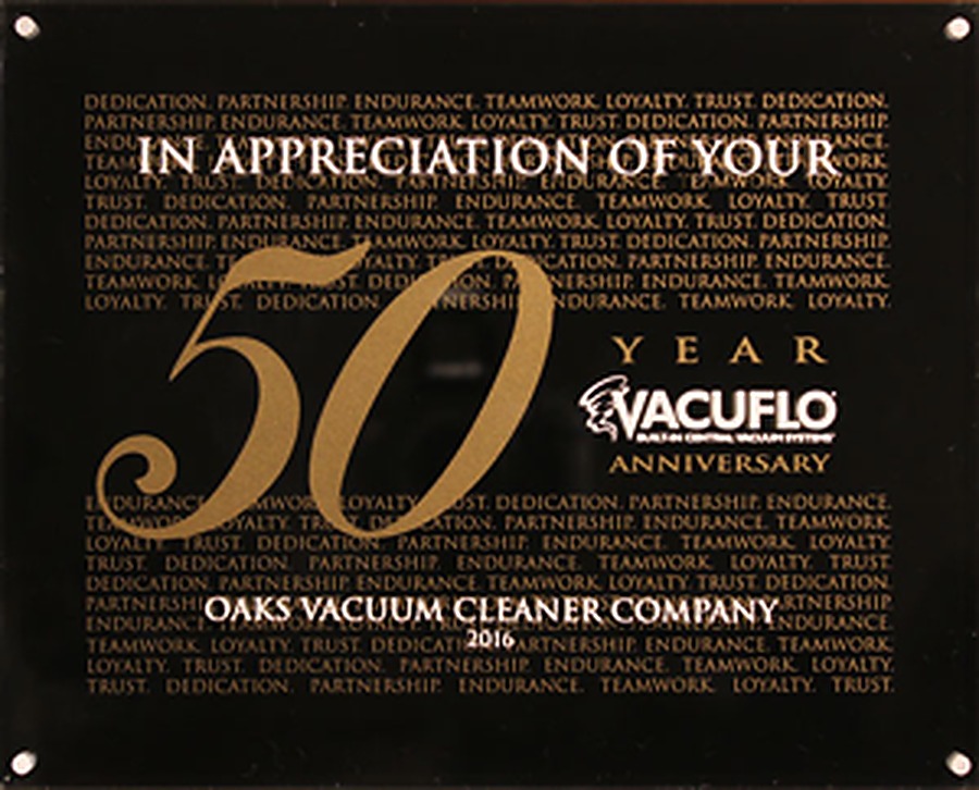 Black and gold VacuFlo plaque awarded to Oaks Vacuum Cleaner Company for fifty years as a VacuFlo dealer